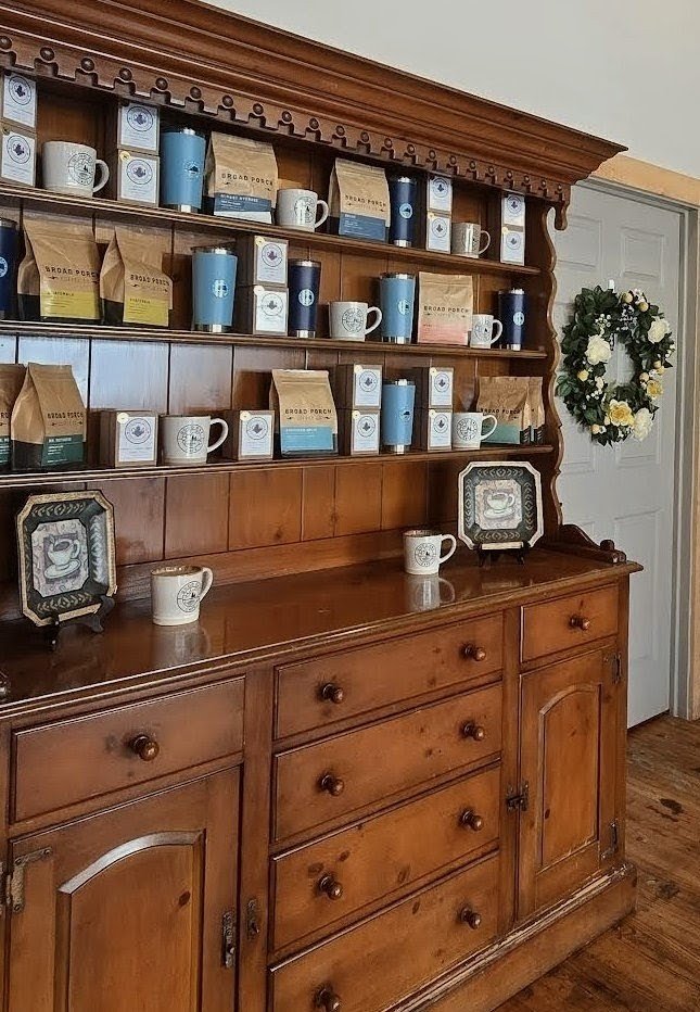 Coffee beans and mugs on the café's wooden hutch