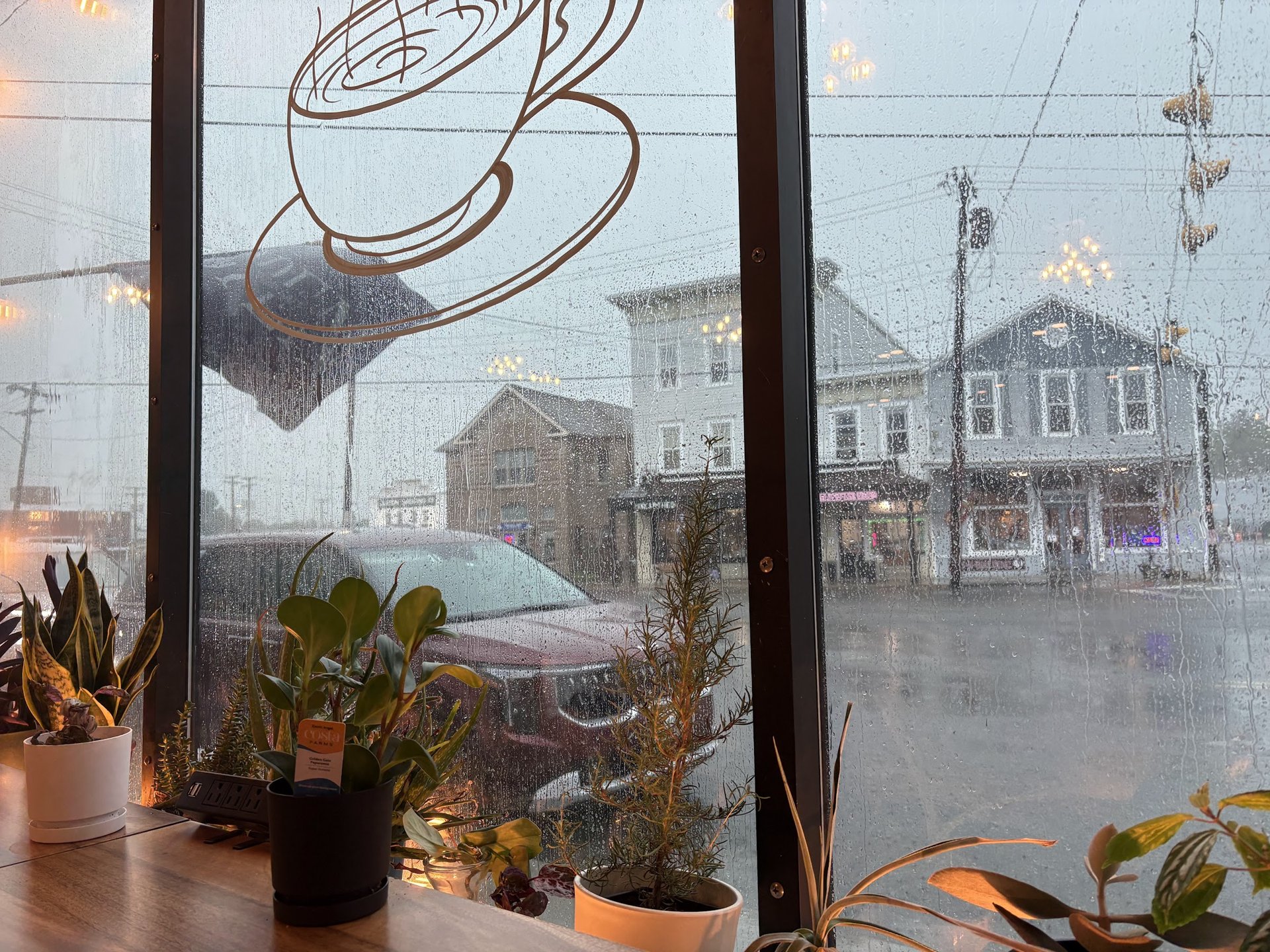 A cozy window seat looking onto Main Street in the rain